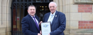 Malcolm Dawson, Head of Security, and Mark Bownass, Deputy Head of Security, with the Secured Environments plaque