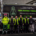 Photo of electric refuse collection vehicle and the waste management team of six people pictured outside the Ziff Buildong at University of Leeds