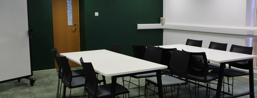 postgraduate lounge main space with desks and chairs
