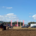 The field at the Research Farm with a tractor ploughing, stands and people are in the background