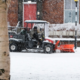 A snow plough clearing snow from a pathway