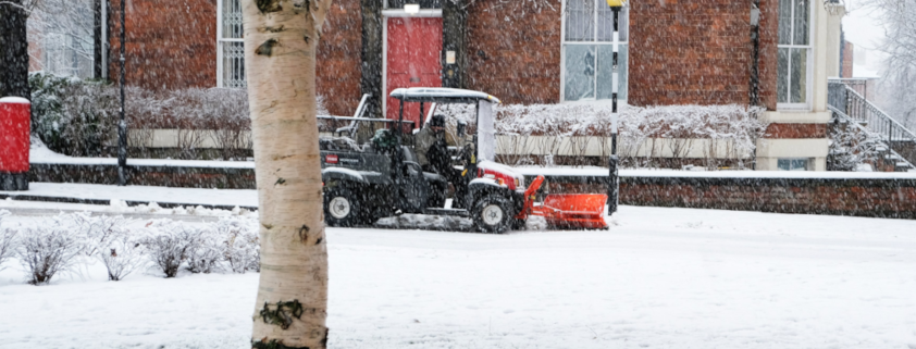 A snow plough clearing snow from a pathway