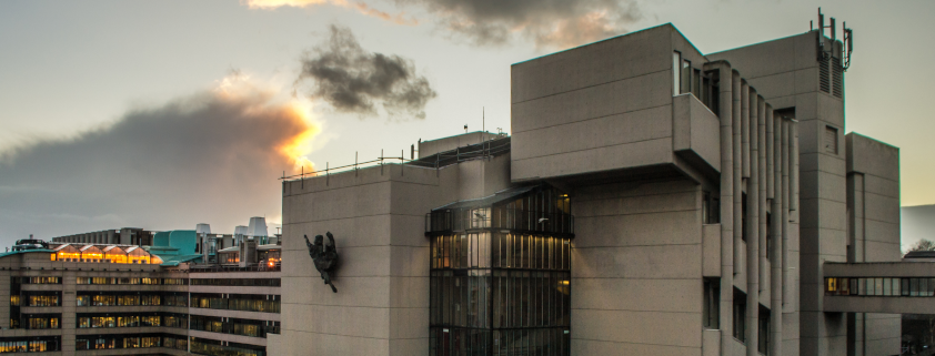 roger stevens building from a panoramic view with the sun setting in the background