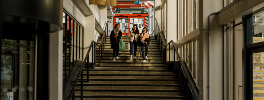 three female students walking down stairs in the Boyle Library