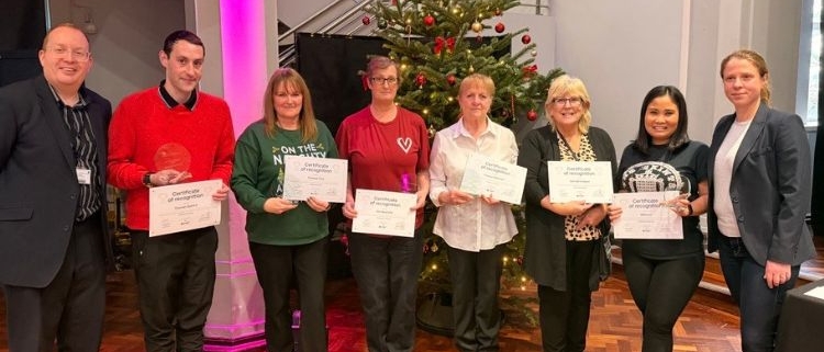 Head of cleaning with award winners at cleaning awards ceremony